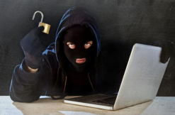 Man in mask uses computer
